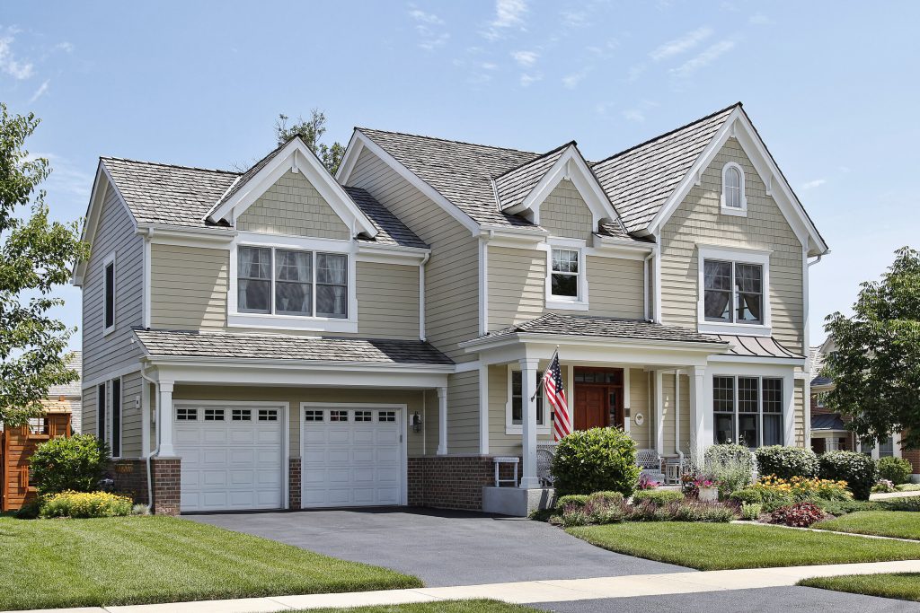 Luxurious suburban home with an American flag on display.