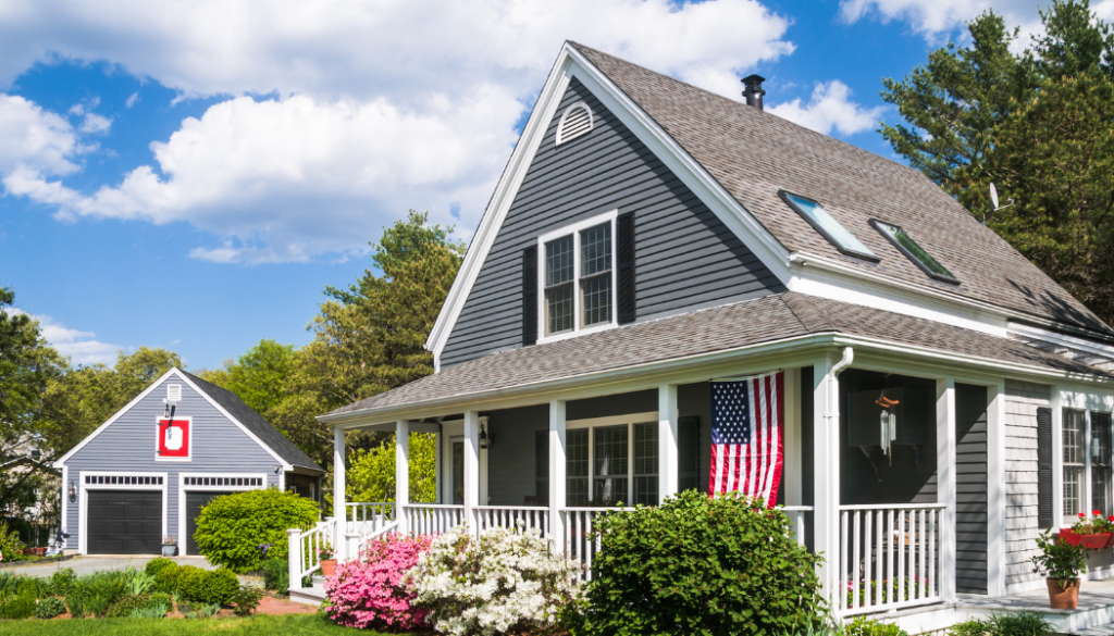 Traditional American house with flags and a garden