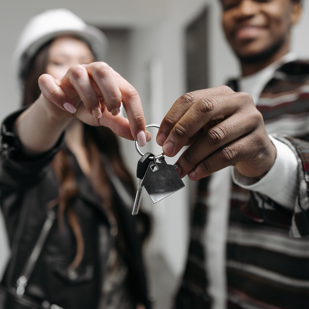 Close-up of hands exchanging a house key